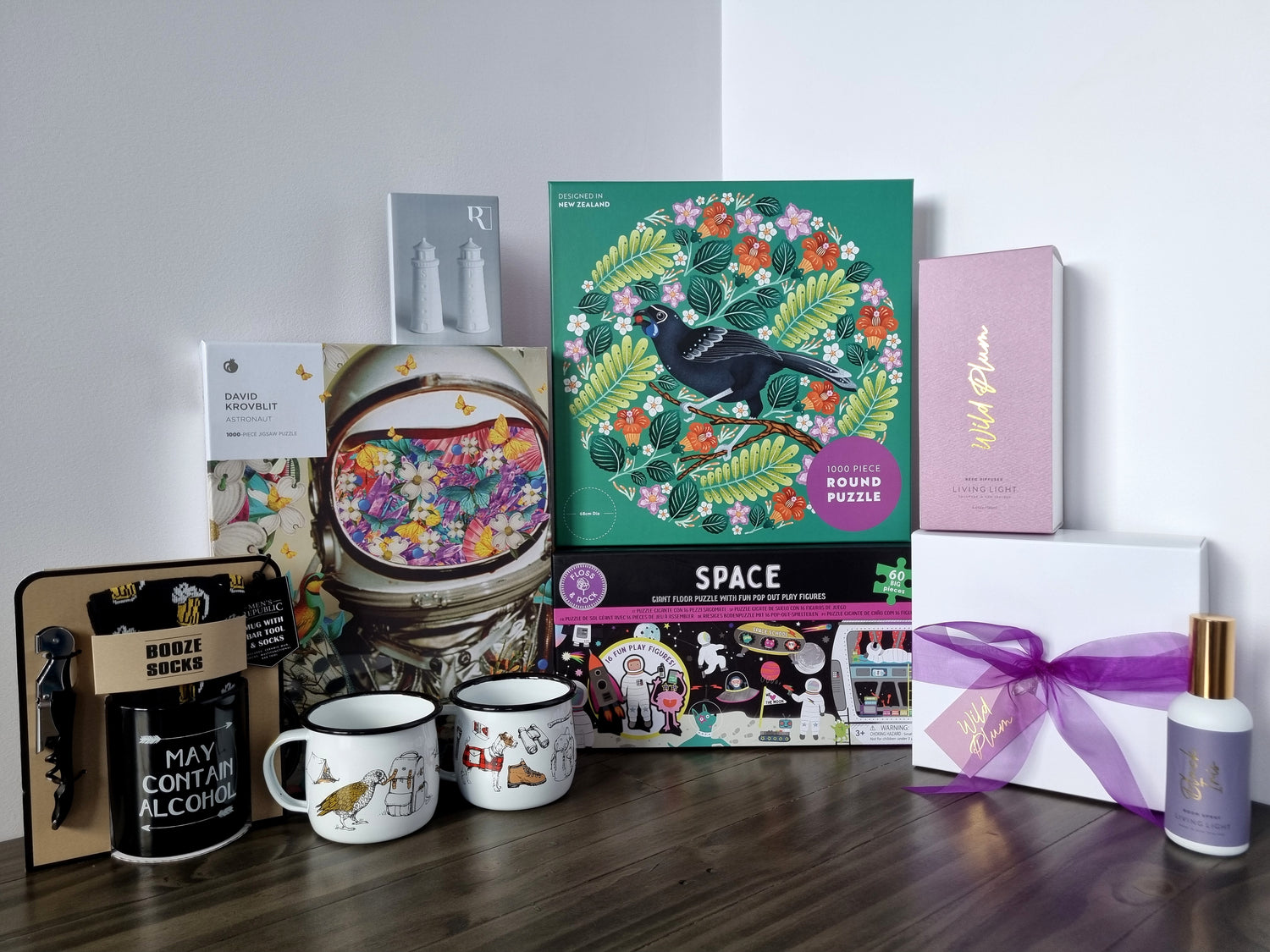 Living light gift set and home fragrance, puzzles, kiwiana enamel mugs, mens republic mug and sock set and lighthouse salt and pepper shakers.