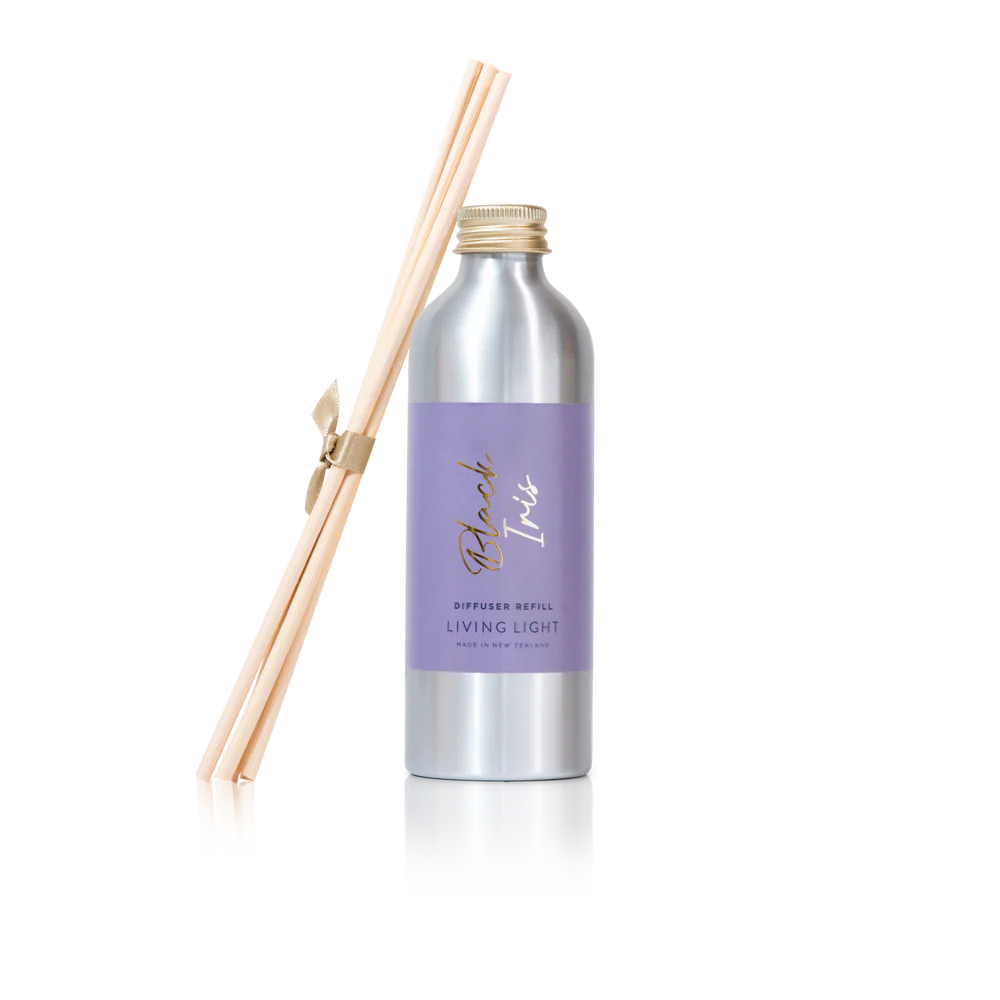 A bottle of black iris scented diffuser refill with replacement reed sticks, made by living light in New Zealand.