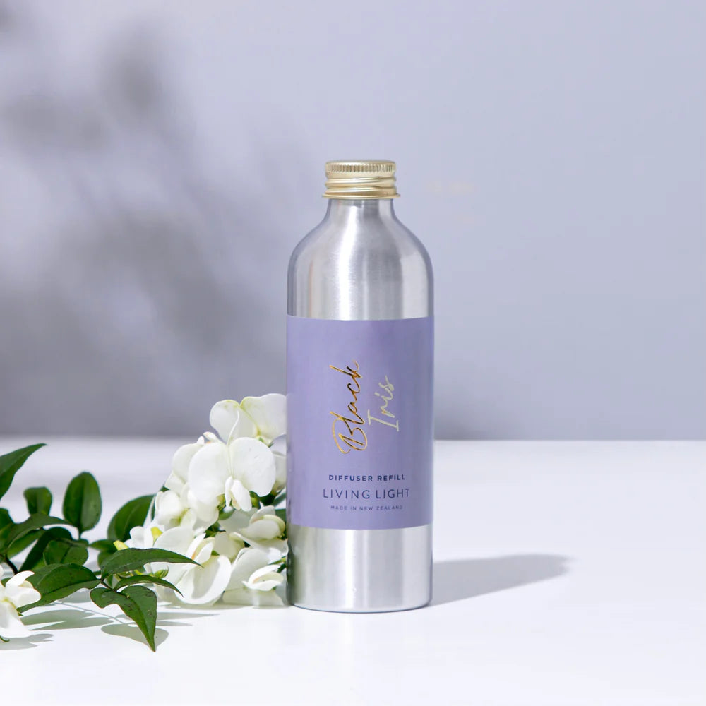 A bottle of black iris scented diffuser refill, made by living light in New Zealand.
