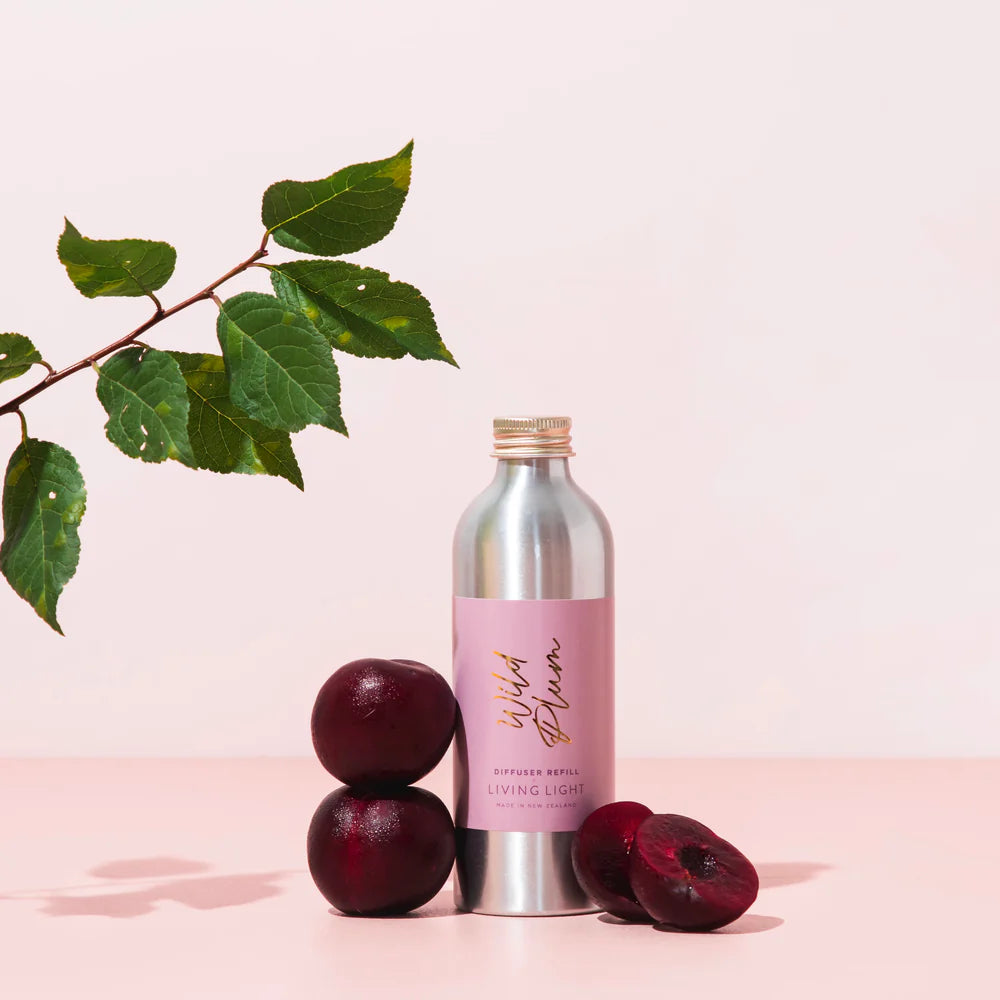 A bottle of wild plum scented diffuser refill made by living light in New Zealand.