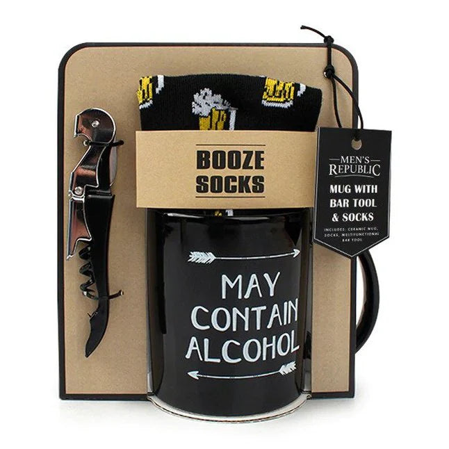 A mens republic gift set containing a black coffee mug featuring the words may contain alcohol in white print, a bar tool and a pair of booze themed socks.