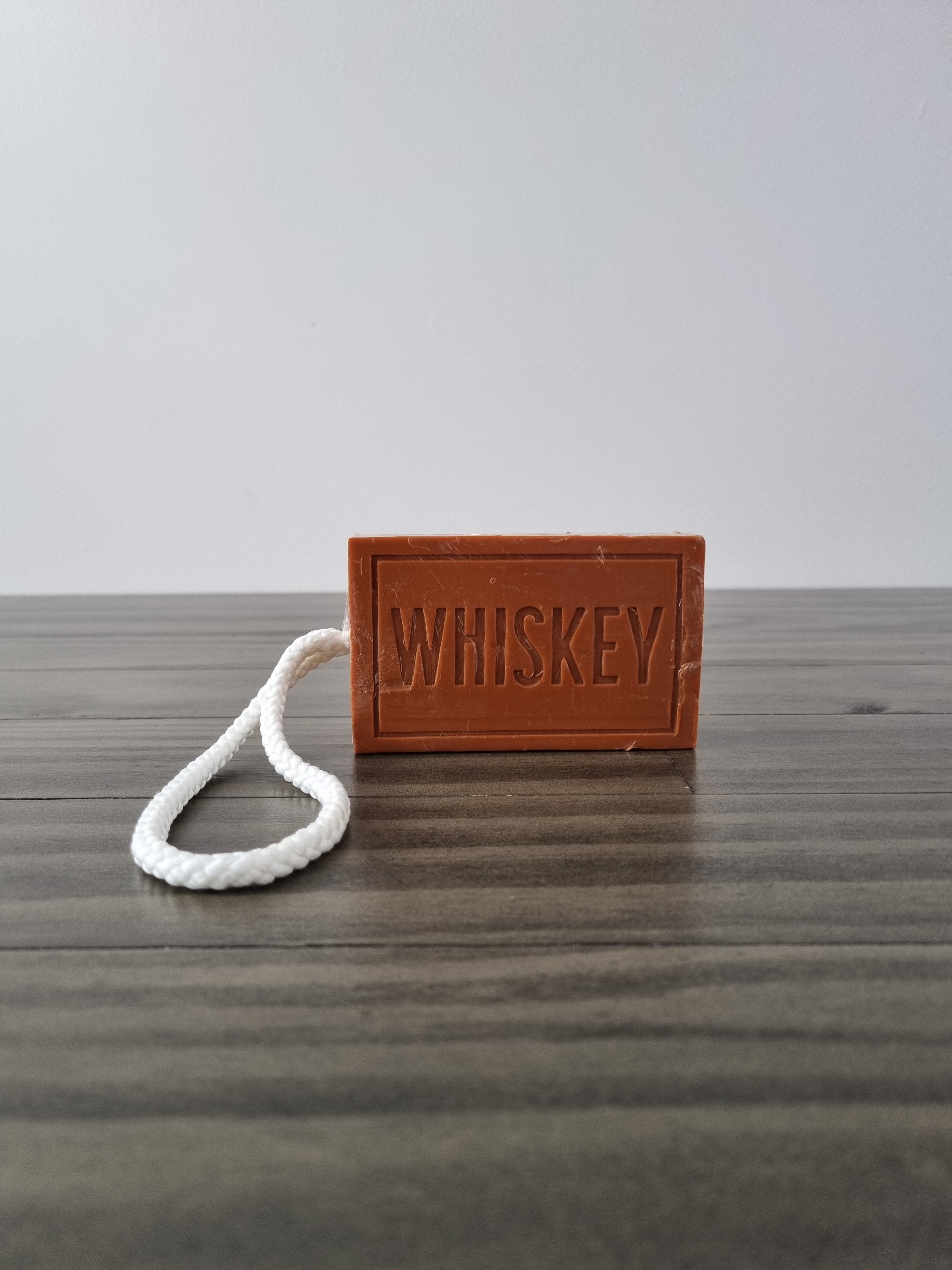 Novelty whiskey scented soap on a rope, imprinted with the word whiskey. Made by mens republic.