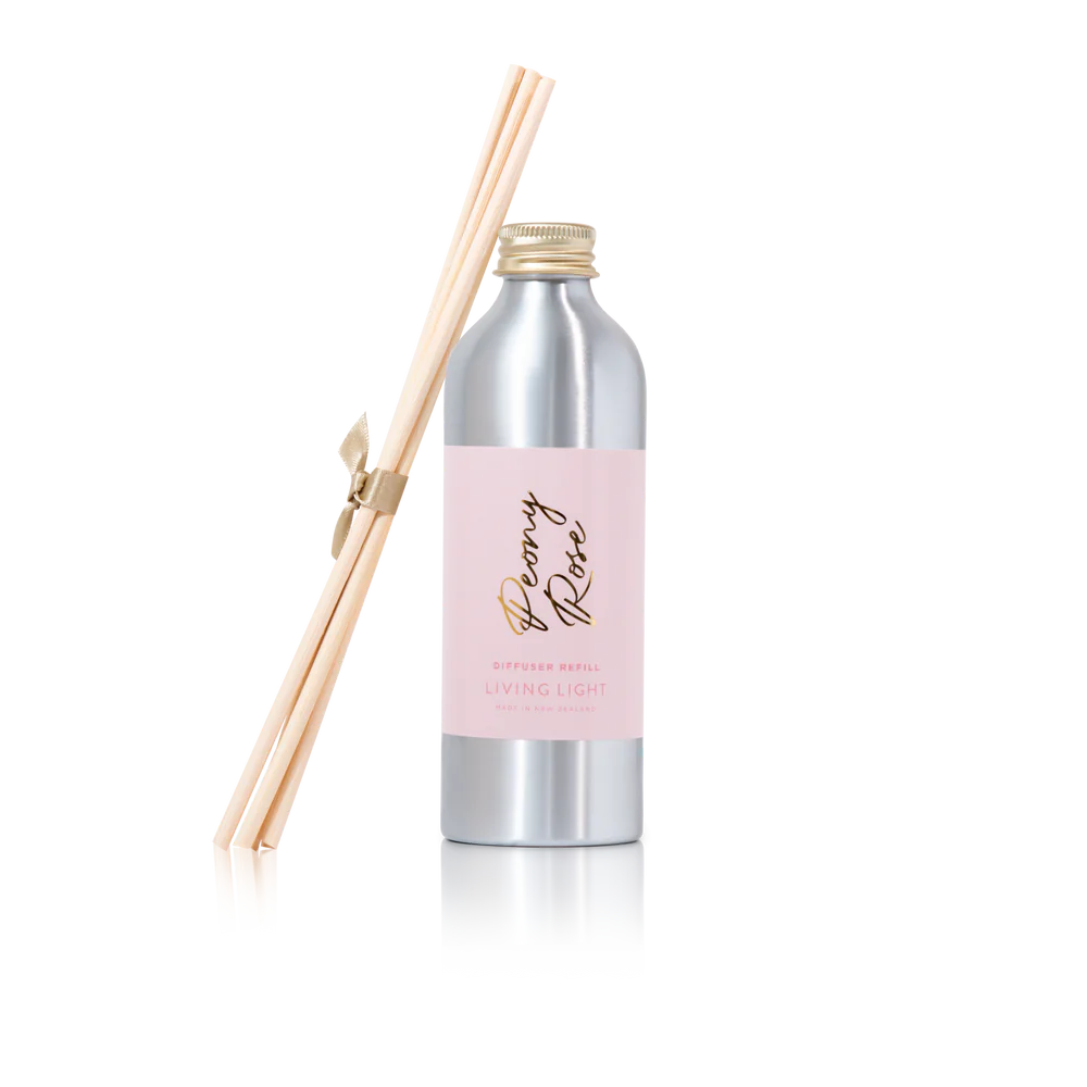 A bottle of peony rose scented diffuser refill with replacement reed sticks, made by living light in New Zealand.