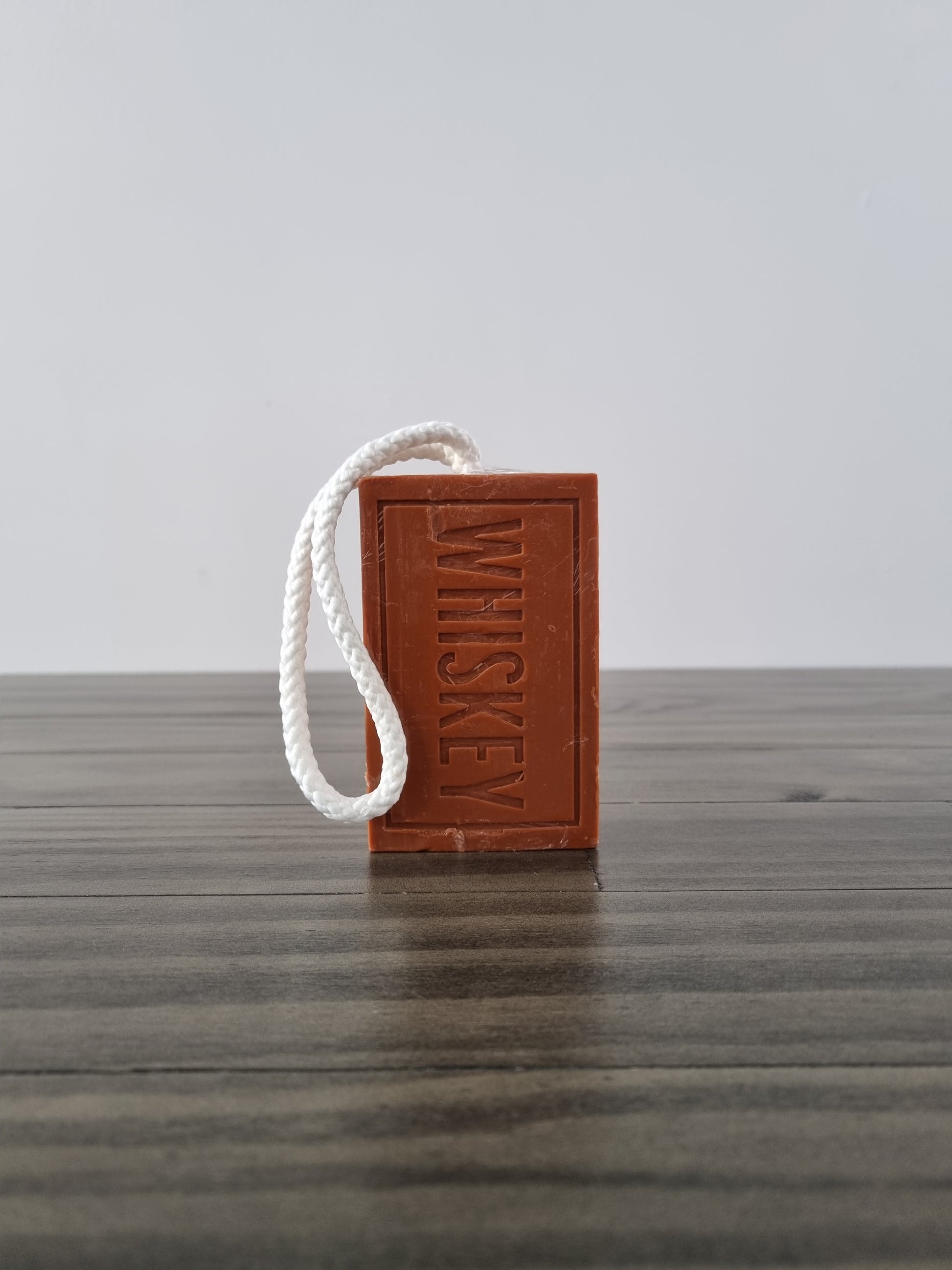 Whiskey scented soap on a rope, imprinted with the word whiskey. Made by mens republic.