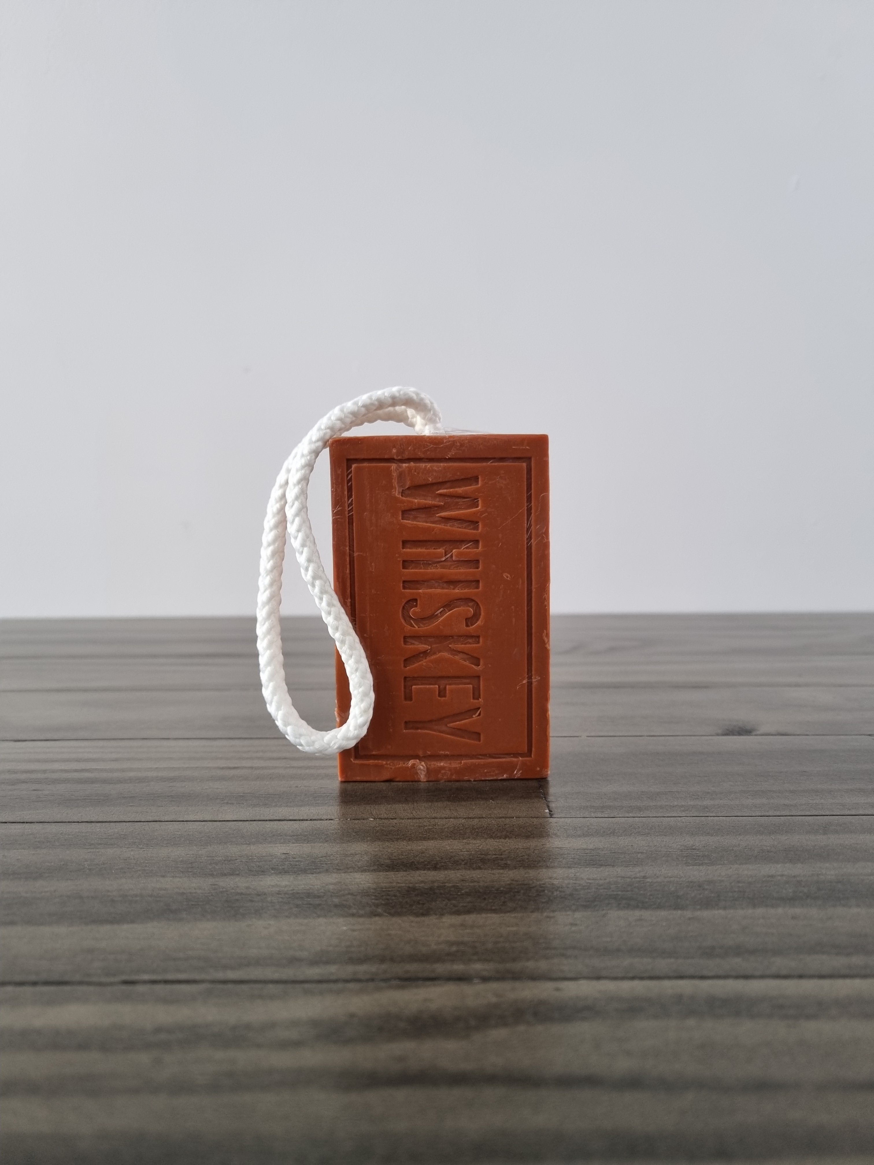 Whiskey scented soap on a rope, imprinted with the word whiskey. Made by mens republic.